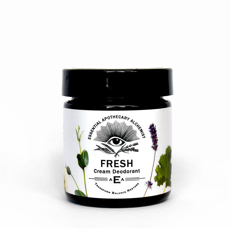 A jar of Fresh Cream Deodorant by Essential Apothecary Alchemy Alchemist, featuring a black lid and a white label with botanical illustrations, set against a plain white background.