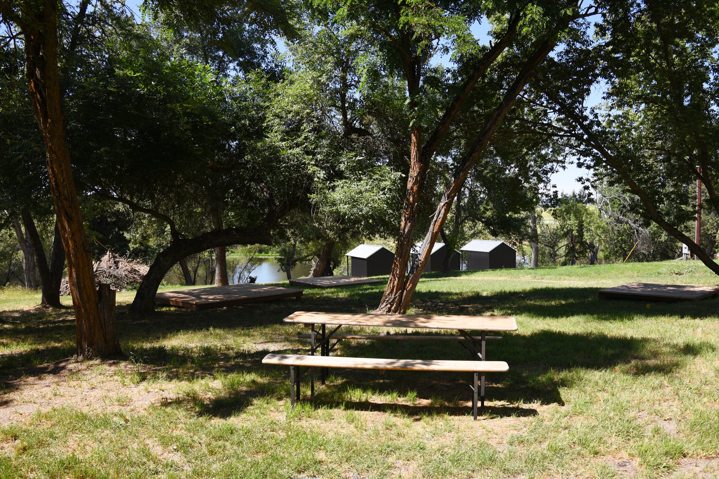 Picnic table next to the pond view cabins at Hunter Moon Homestead