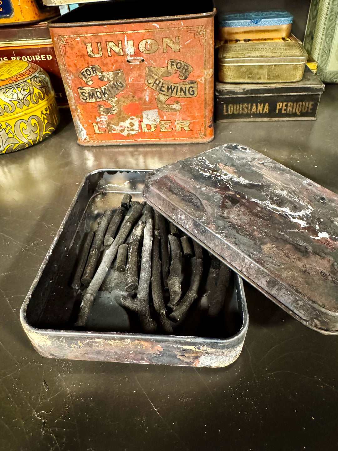 handmade willow charcoal in a tin