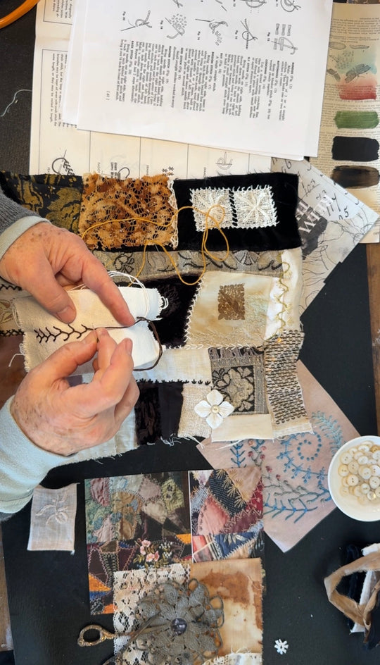 Kate Poole working on a "crazy quilt" patchwork quilt with various fabrics and patterns.