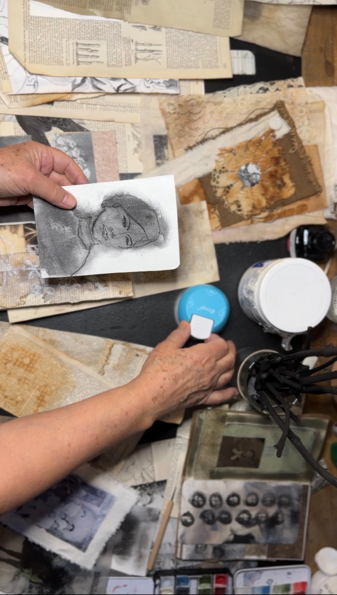 Artist Kate Poole working with charcoal sketches and printing equipment in the studio