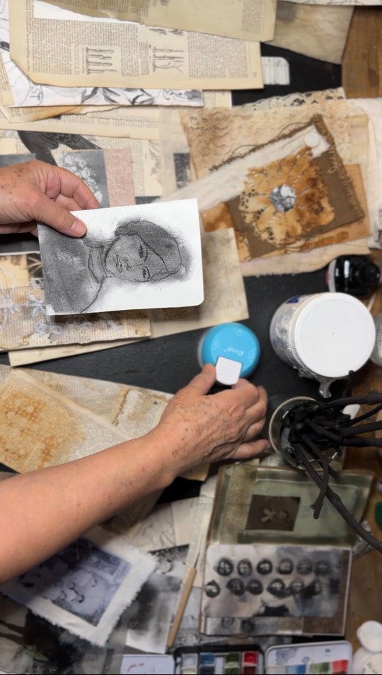 Artist Kate Poole working with charcoal sketches and printing equipment in the studio