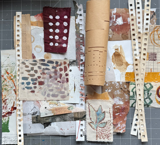 Collection of textured paper samples on a gray surface
