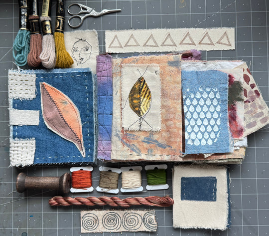 Textile art project with fabric samples and embroidery tools on a grid background
