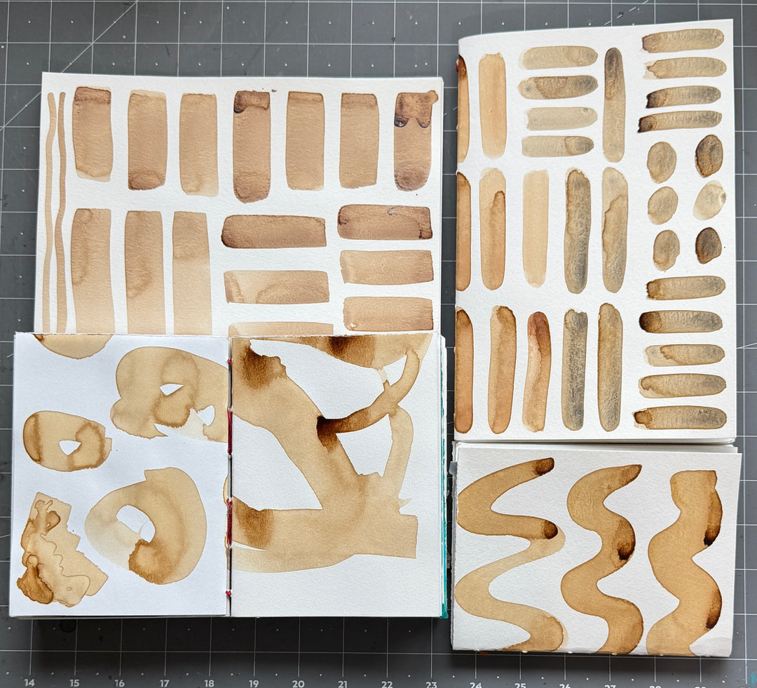 Collection of natural ink marks on watercolor paper