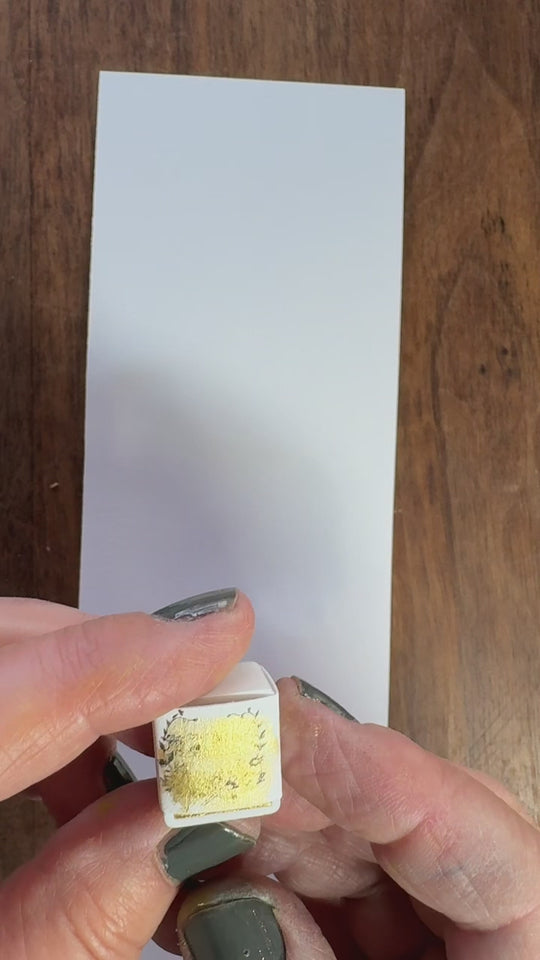 Golden watercolor paint swatch