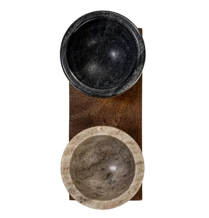 Two stone bowls on a wooden stand with a white background
