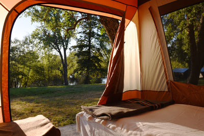 Glamping tent platform with luxury cot at Hunter Moon Homestead